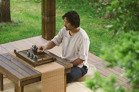 "Man Drinking Tea In A Garden" by Stocksy Contributor "MaaHoo" - Stocksy