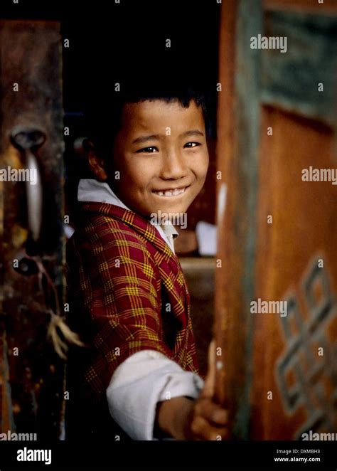 Young boy opening painted window shutters in Thimpu, Bhutan. Digitally ...