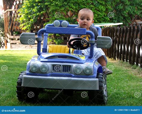 Boy driving a toy car stock photo. Image of baby, carefree - 12901708