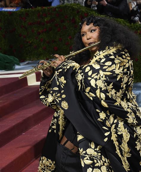 Lizzo Plays Gold John Lunn Flute on Met Red Carpet