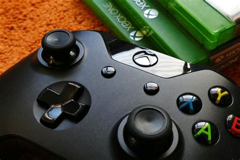 Xbox One Controller Beside Three Xbox One Cases · Free Stock Photo