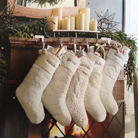 pottery barn white stockings with candles and greenery and star *mantle