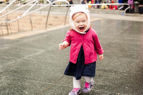 Caucasian girl laughing at park stock photo