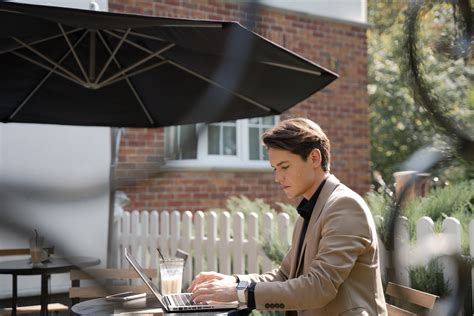 A Businessman Using a Laptop Outdoor · Free Stock Photo