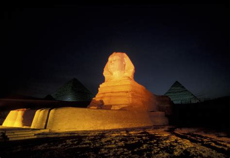 Pyramids And A Sphinx At Night In Giza by Richard Nowitz