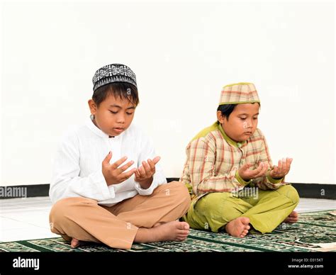Muslim kids praying at school Stock Photo - Alamy