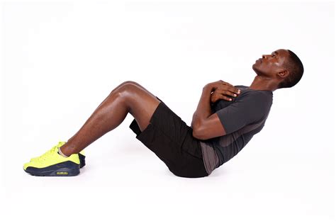 Athletic man doing sit up crunches exercise