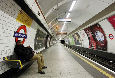 A passenger waits for a tube train that did not arrive on an empty ...