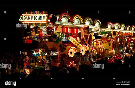 floats lit up at night with music playing during the bridgwater carnival season with spectators ...