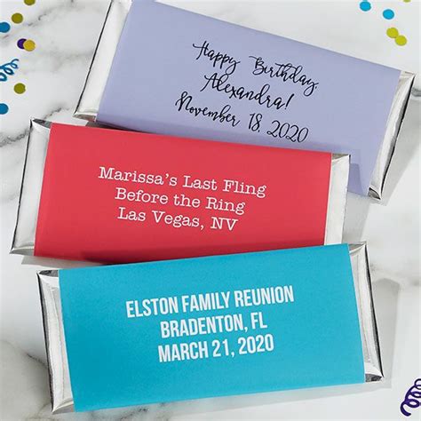 three personalized candy bars are sitting on a marble table with confetti and streamers