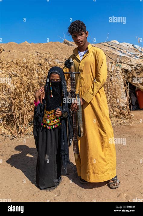 Portrait of Rashaida tribe teenage boy and girl in traditional clothing ...