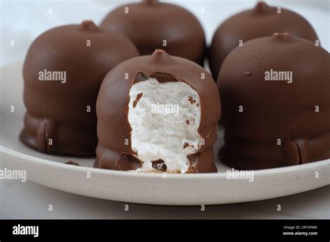 Chocolate-coated marshmallow. Krembo on the table with a cookies. Classic Israeli childhood ...