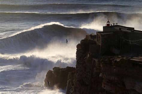 Photos: Massive waves tempt surfers off Portugal's coast | KCBY