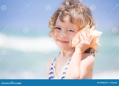 Child with seashell stock photo. Image of leisure, face - 39282512