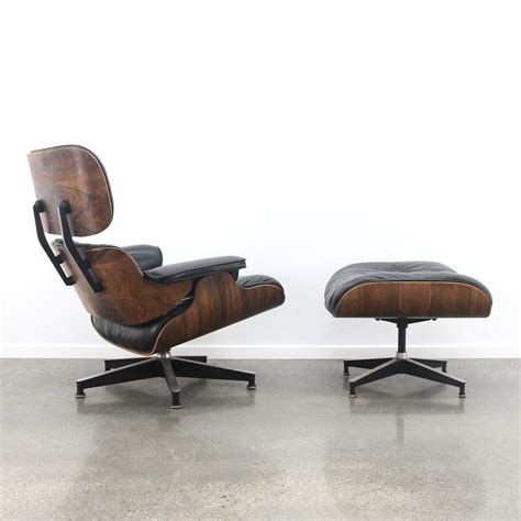 Eames lounge chair + ottoman in black leather/rosewood, 1960s | #82167