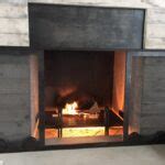 Beautiful modern fireplace with sliding doors by Acutech Metalworks. - Acutech Fabrication