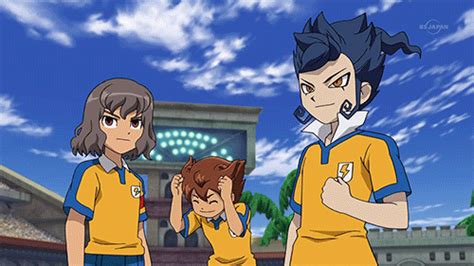 two people in yellow and blue uniforms stand next to each other with their hands on their heads
