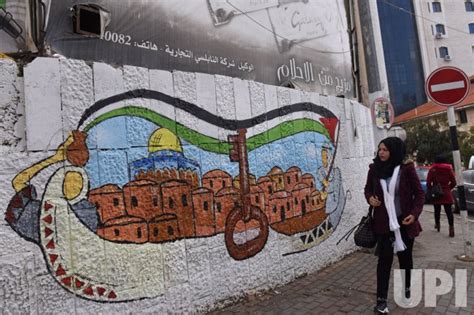 Photo: A Palestinian Walks Past Graffiti Of Jerusalem In Ramallah ...