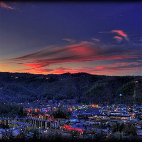 the city is lit up at night with colorful lights on it's buildings and ...