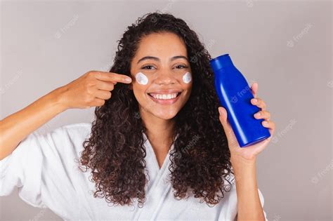 Premium Photo | Brazilian black woman wearing bathrobe and towel face cream spa beauty center ...