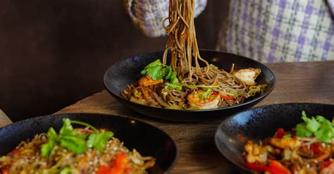 Woman Eating Noodles with Chopsticks · Free Stock Photo