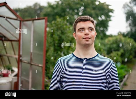 Down syndrome adult man walking outdoors in vegetable garden Stock Photo - Alamy