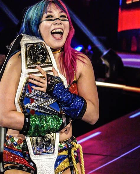 Pink-haired WWE Female Wrestler with Championship Belt