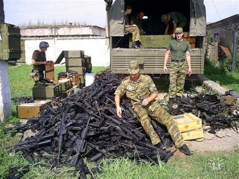 Russian soldiers check weapons that Georgian army left behind during ...