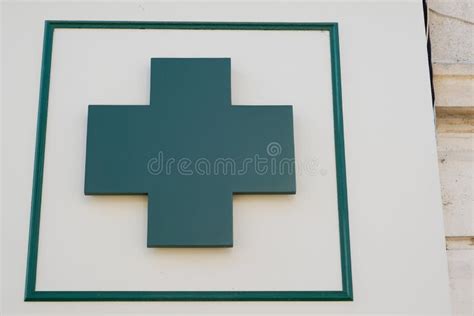 Green Cross Logo of Pharmacy Sign in Street Stock Photo - Image of ...