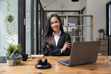 Premium Photo | Asian business lawyer woman smiling at camera at workplace in an office