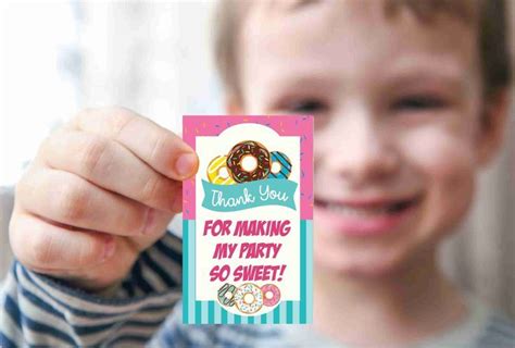 a young boy holding up a thank you card for making my party 50 sweet donuts