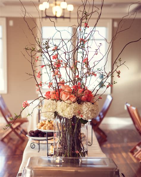 Spring centerpiece. Flowering quince branches. White hydrangeas. Coral ...