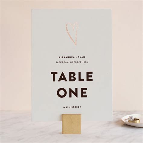 a white table sign sitting on top of a marble counter