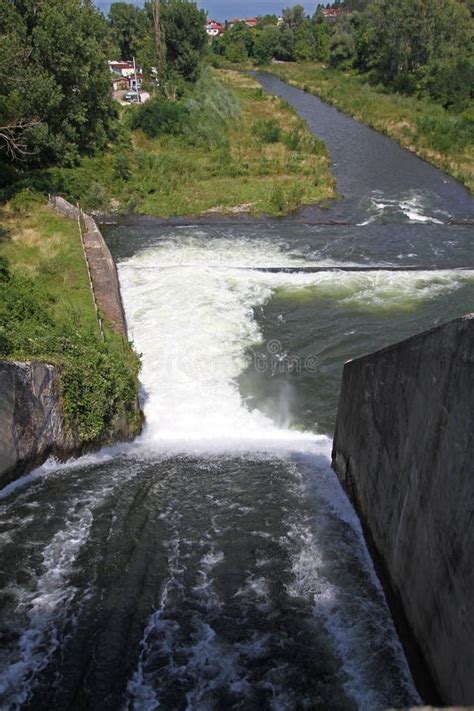 Dam Wall and Overflow of Iskar Dam. Water Flowing Over a Dam Wall. Mist Rising Above the Iskar ...