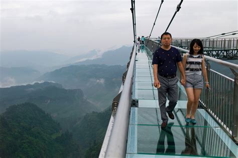 Panels on Chinese glass bridge fall out during gale-force winds, leaving tourist traumatised ...