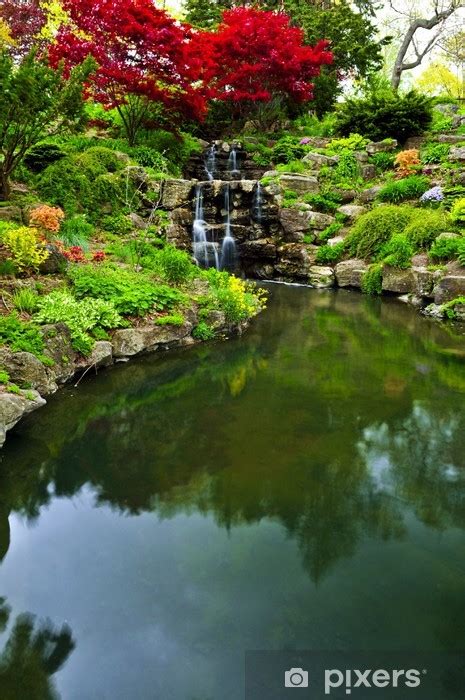 Wall Mural Cascading waterfall and pond in japanese garden - PIXERS.UK