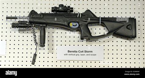 A Beretta Cx4 Storm with vertical grip, laser, and scope displayed at ...