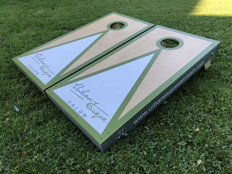 two cornhole boards sitting in the grass