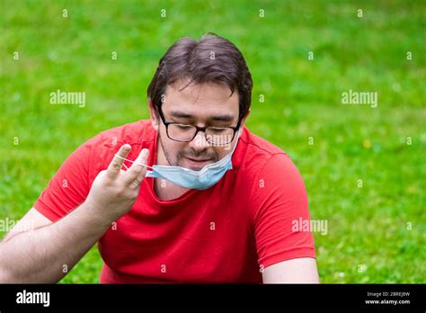 Man wearing surgical mask while he is outside Stock Photo - Alamy