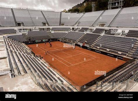 Rome Tennis Stadium. Two tennis players practice with their trainer in ...