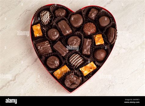 Delicious chocolates in a heart shaped box Stock Photo - Alamy