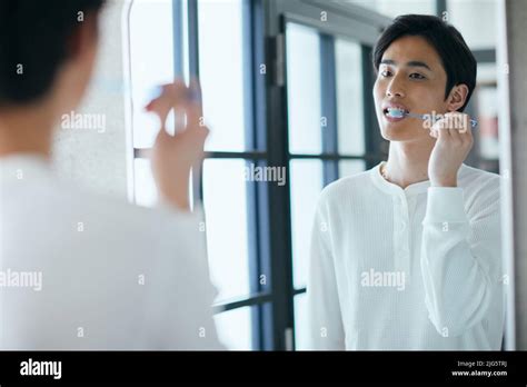 Japanese man brushing teeth Stock Photo - Alamy