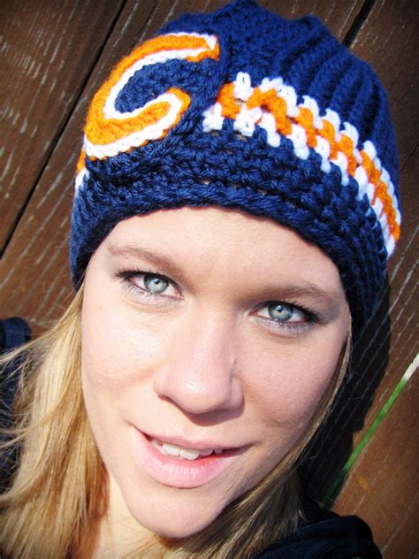 a woman wearing a crocheted hat with the chicago bears on it