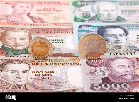 Colombian Peso coins on the background of banknotes Stock Photo - Alamy