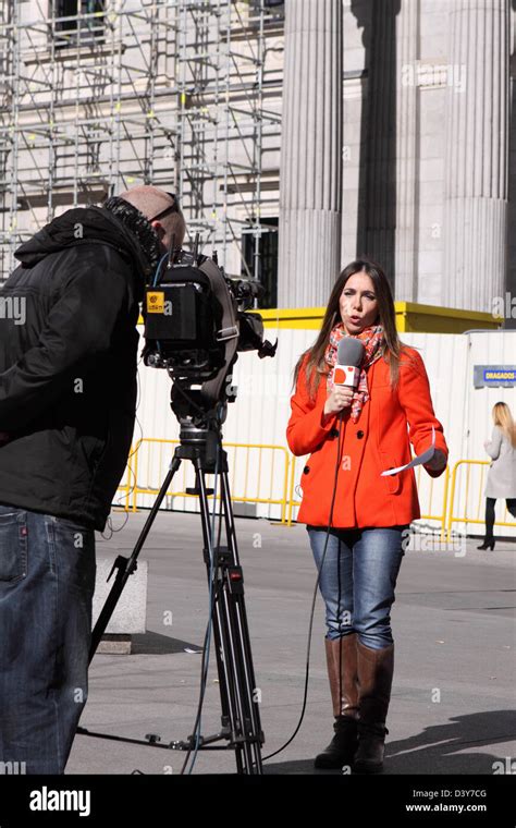 Female TV news reporter journalist and film crew cameraman recording in Madrid Spain Stock Photo ...
