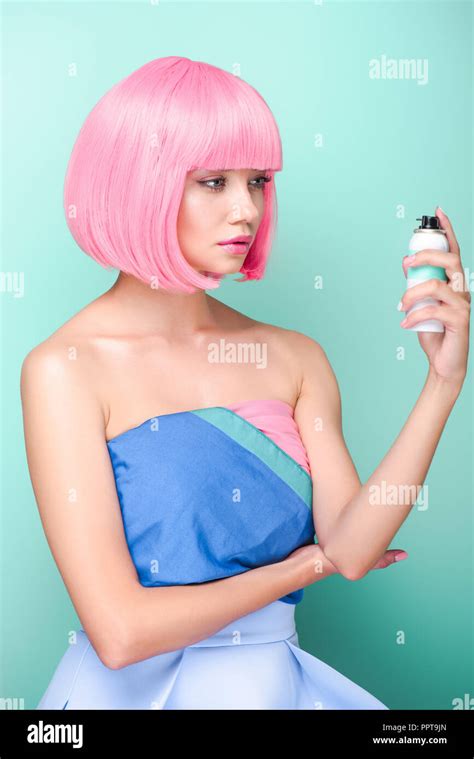 stylish young woman with pink bob cut holding coloring hair spray ...