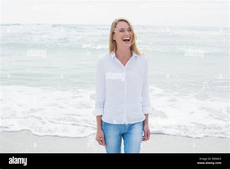 Casual woman laughing at beach Stock Photo - Alamy