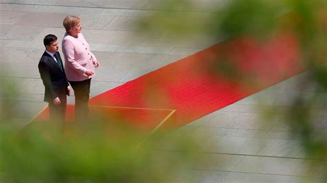 Angela Merkel 'doing well' after visibly shaking at Berlin ceremony ...