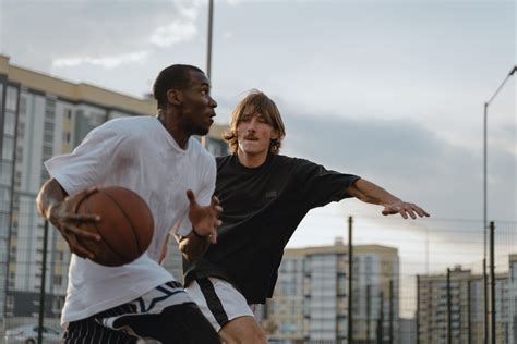 Man in White Long Sleeve Shirt Holding Basketball · Free Stock Photo