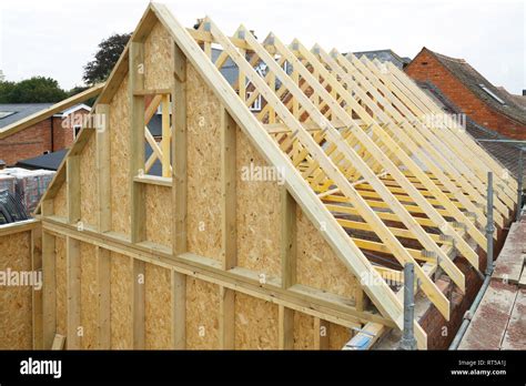 Gable and wooden roof trusses to a timber frame house under construction Stock Photo - Alamy